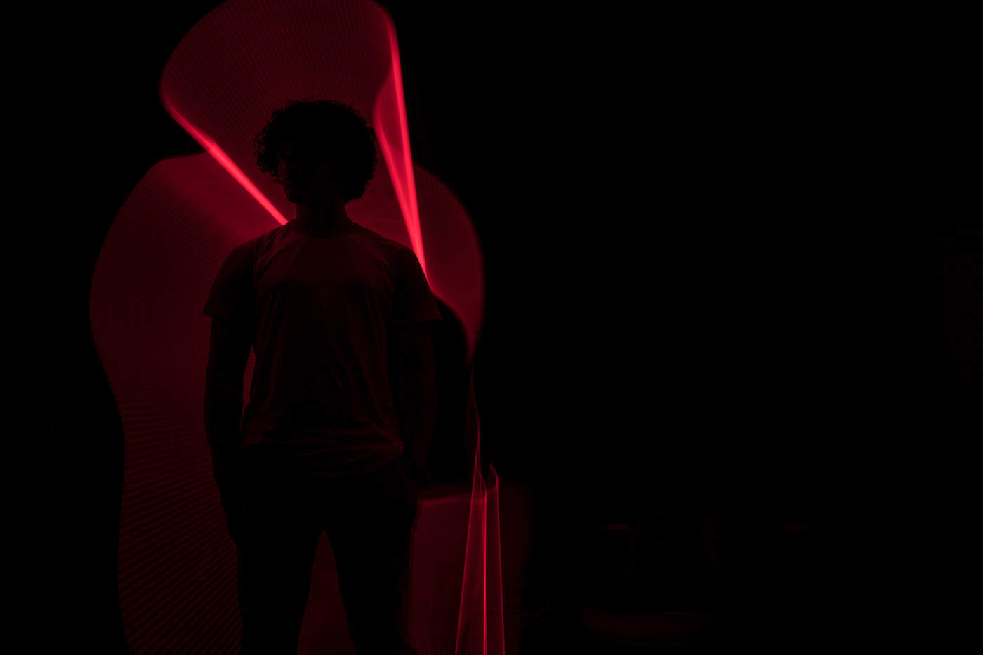 Silhouette with red light trails