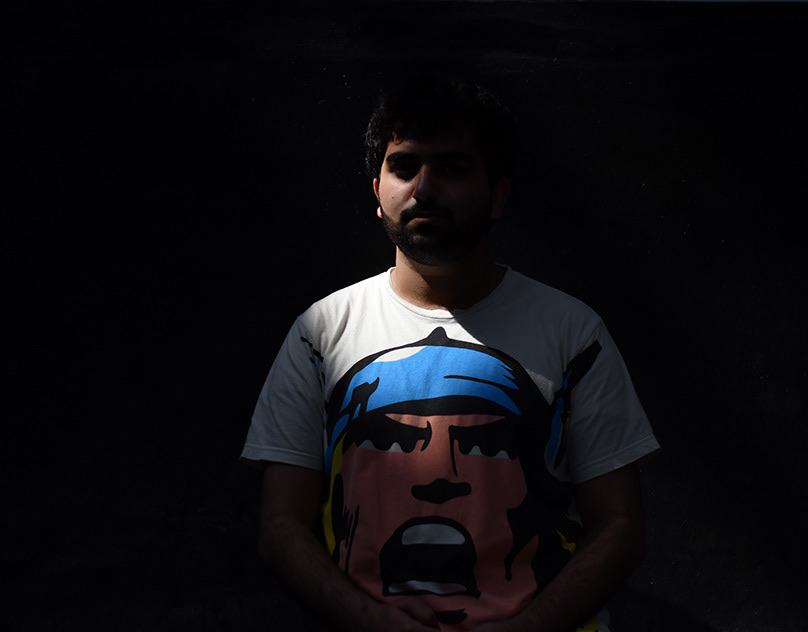Low-key portrait of a man in a printed t-shirt