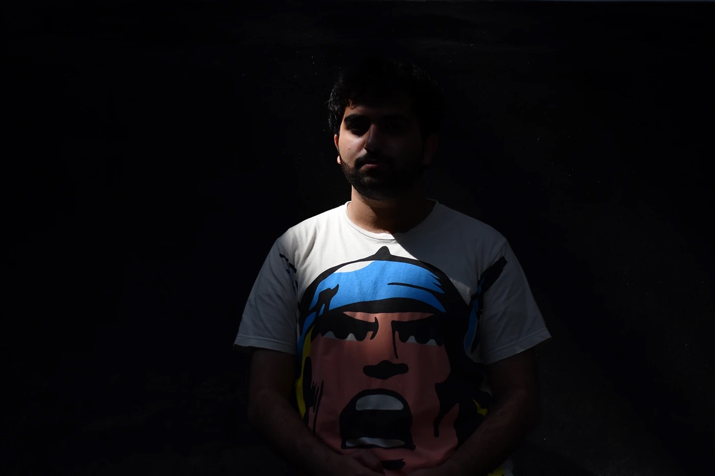 Low-key portrait in a printed t-shirt