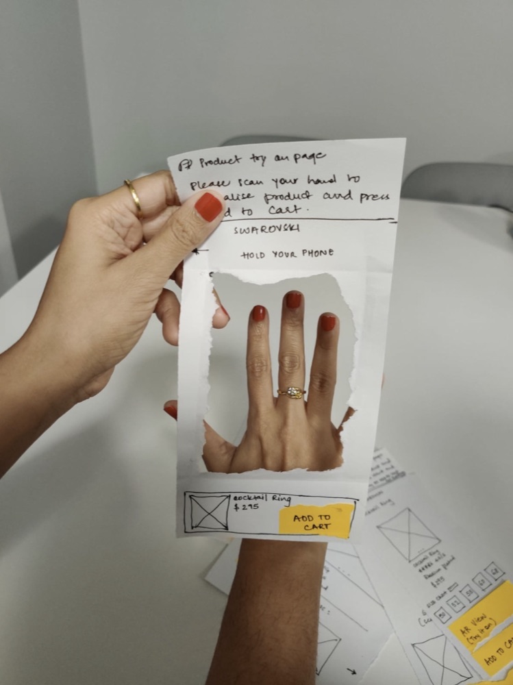 Testing a paper AR try-on screen on a hand