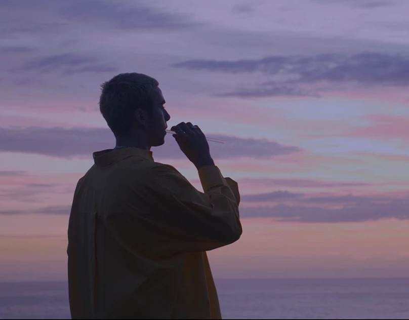 Silhouette of a man against a purple dusk sky