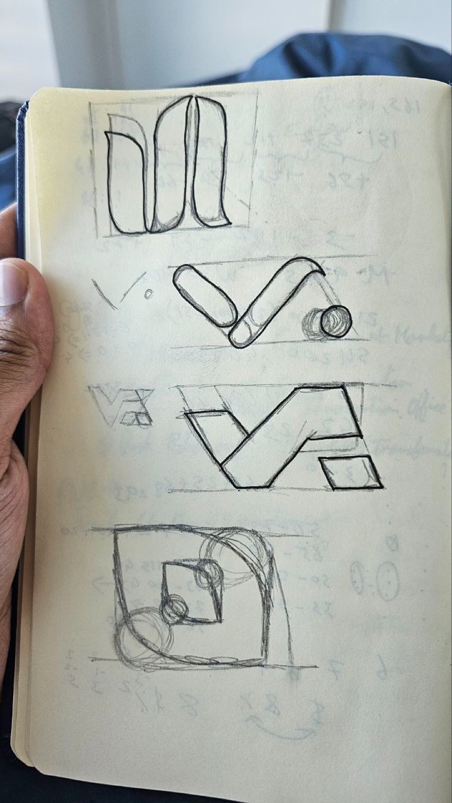 Sketchbook page of further logo concept sketches
