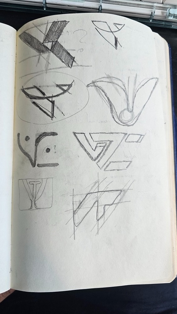 Sketchbook page of early V, T and C logo sketches