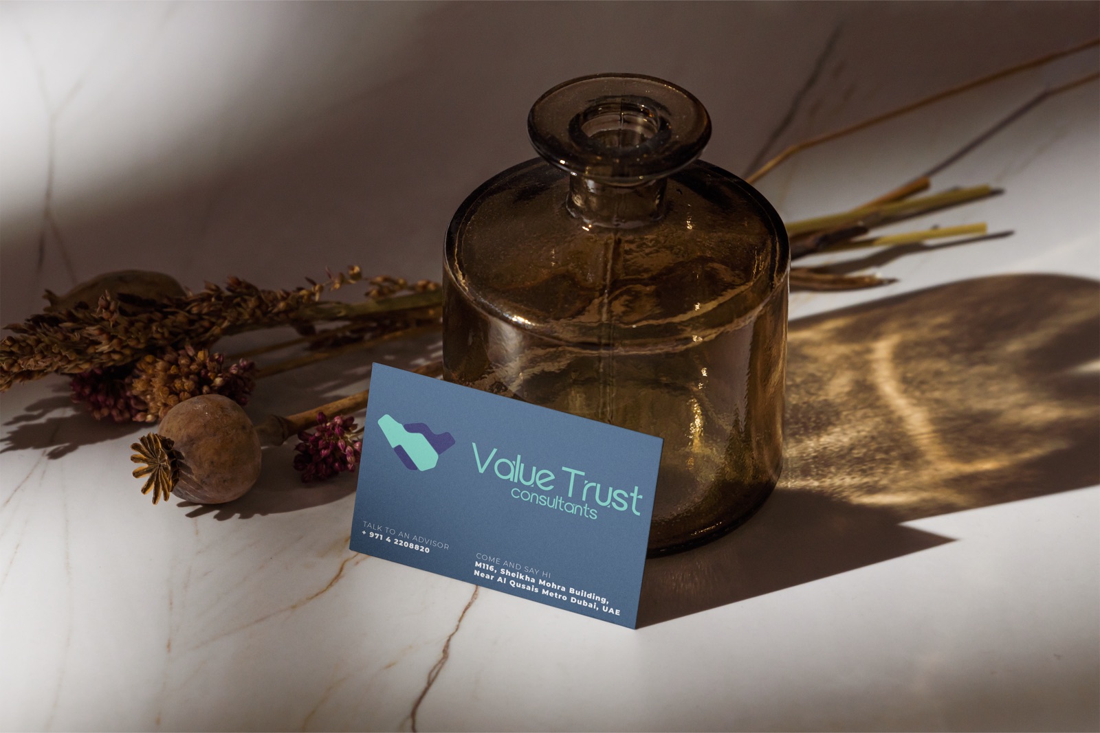 Value Trust business card beside a glass vase